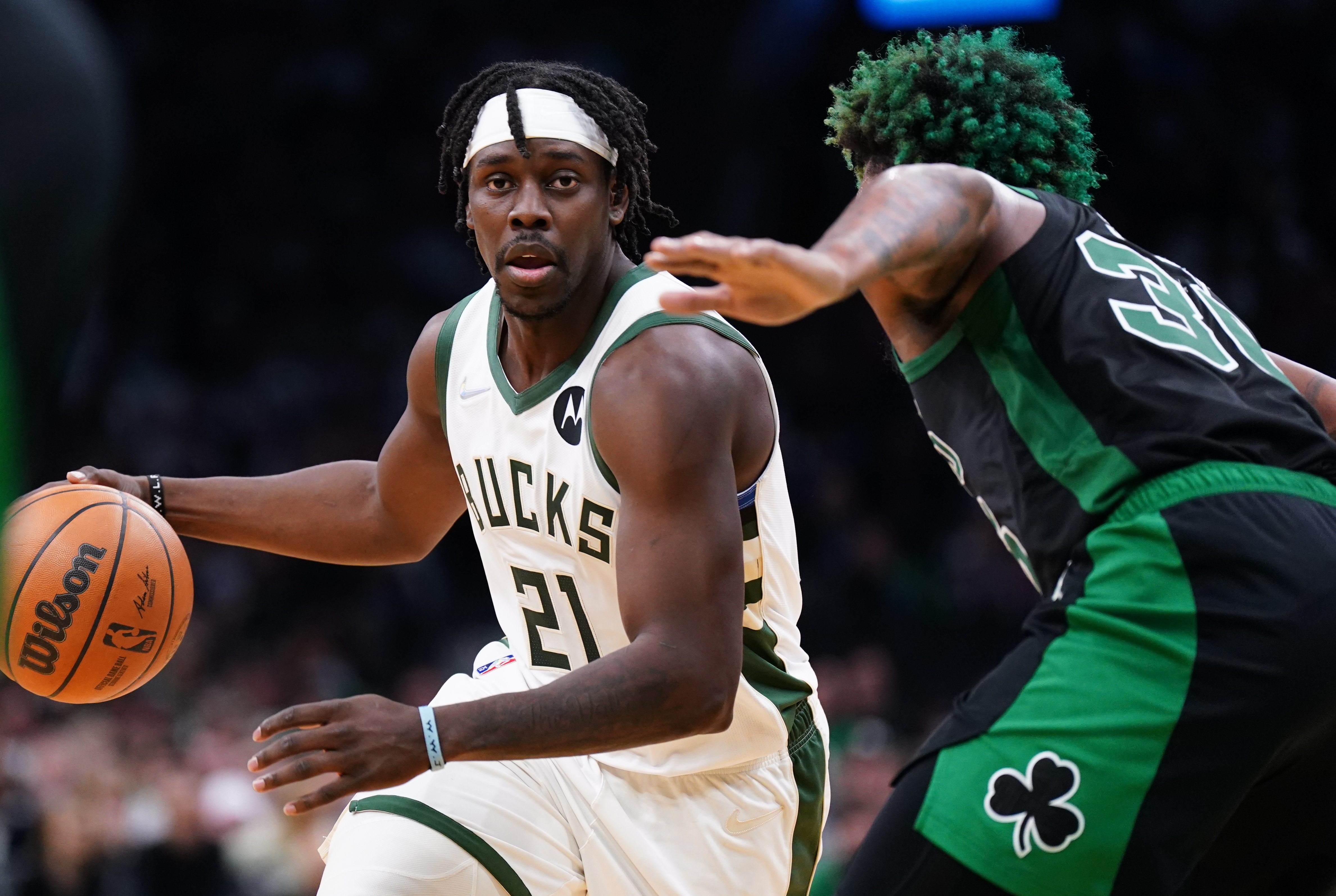 Milwaukee Bucks guard Jrue Holiday (21) drives the ball against Boston Celtics guard Marcus Smart (36) in the second half during game one of the second round for the 2022 NBA playoffs at TD Garden.