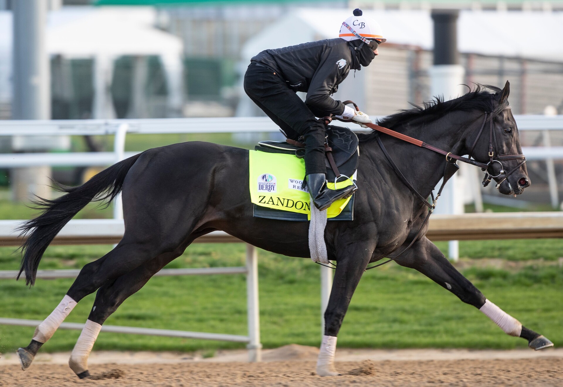 Trainer Chad Brown guides Kentucky Derby hopeful Zandon through a workout on the track at Churchill Downs.