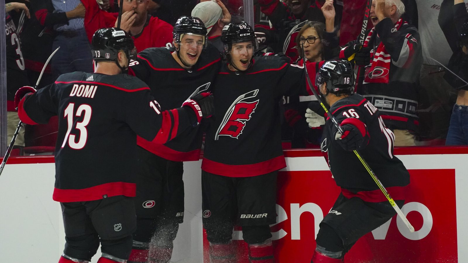 Carolina Hurricanes left wing Teuvo Teravainen (86) is congratulated by left wing Jordan Martinook (48) defenseman Brady Skjei (76) and center Max Domi (13) after this goal against the Boston Bruins during the third period in game one of the first round of the 2022 Stanley Cup Playoffs at PNC Arena.