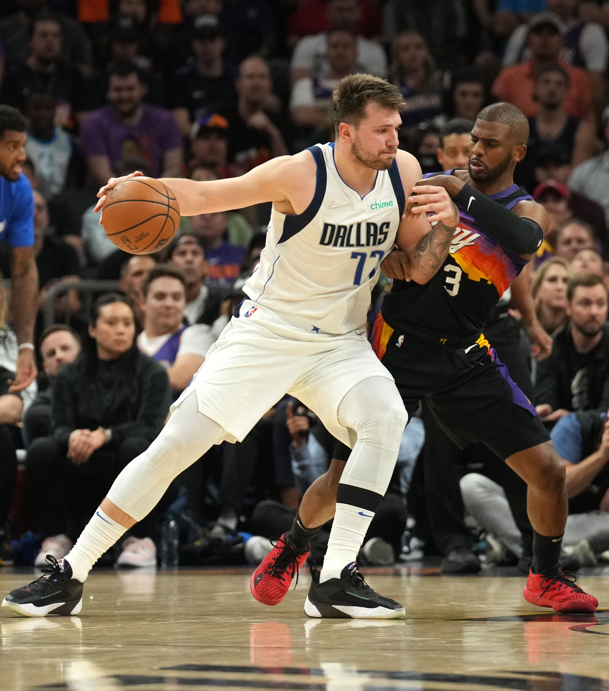 Phoenix Suns guard Chris Paul, right, guards Dallas Mavericks guard Luka Doncic, right, during the first half of game one of the second round for the 2022 NBA playoffs at Footprint Center on May 2, 2022.