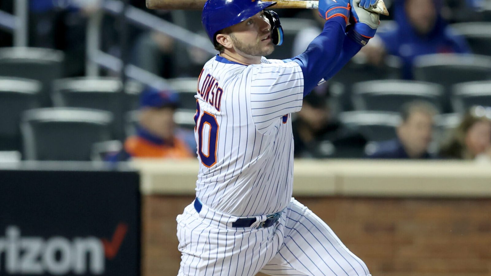 New York Mets first baseman and designated hitter Pete Alonso follows through on his swing and watches his a solo home run leave the ballpark against the Atlanta Braves