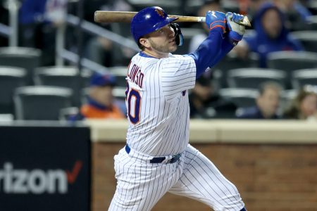 New York Mets first baseman and designated hitter Pete Alonso follows through on his swing and watches his a solo home run leave the ballpark against the Atlanta Braves