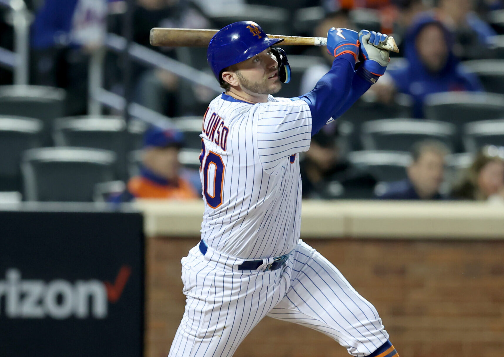 New York Mets first baseman and designated hitter Pete Alonso follows through on his swing and watches his a solo home run leave the ballpark against the Atlanta Braves