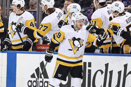 Pittsburgh Penguins left wing Jake Guentzel (center, on the ice) celebrates his goal with teammates against the New York Rangers