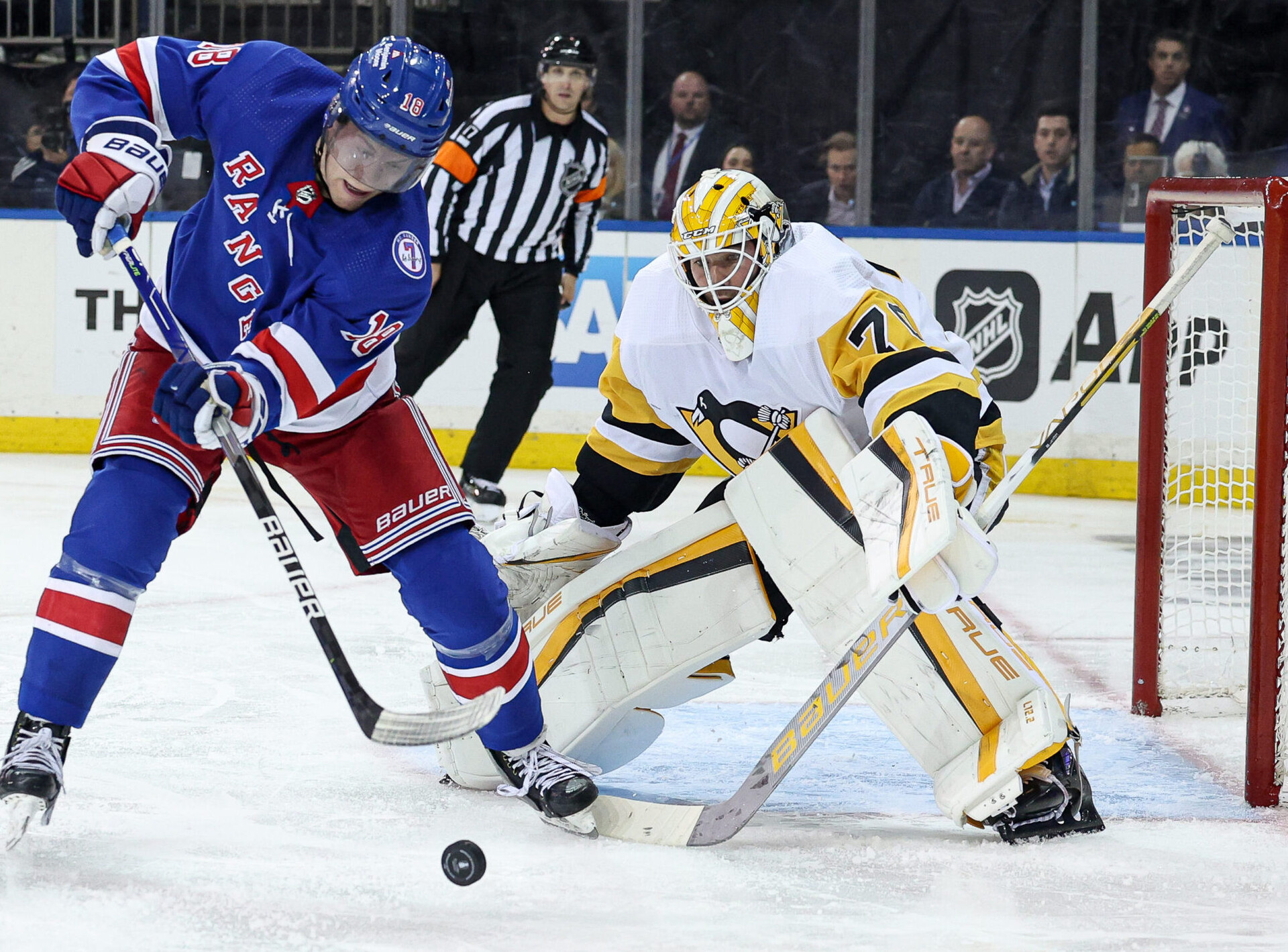 New York Rangers center Andrew Copp (left) looks to control the puck and shoot it past Pittsburgh Penguins goaltender Louis Domingue (right) during the third overtime in game one of the first round of the 2022 Stanley Cup Playoffs
