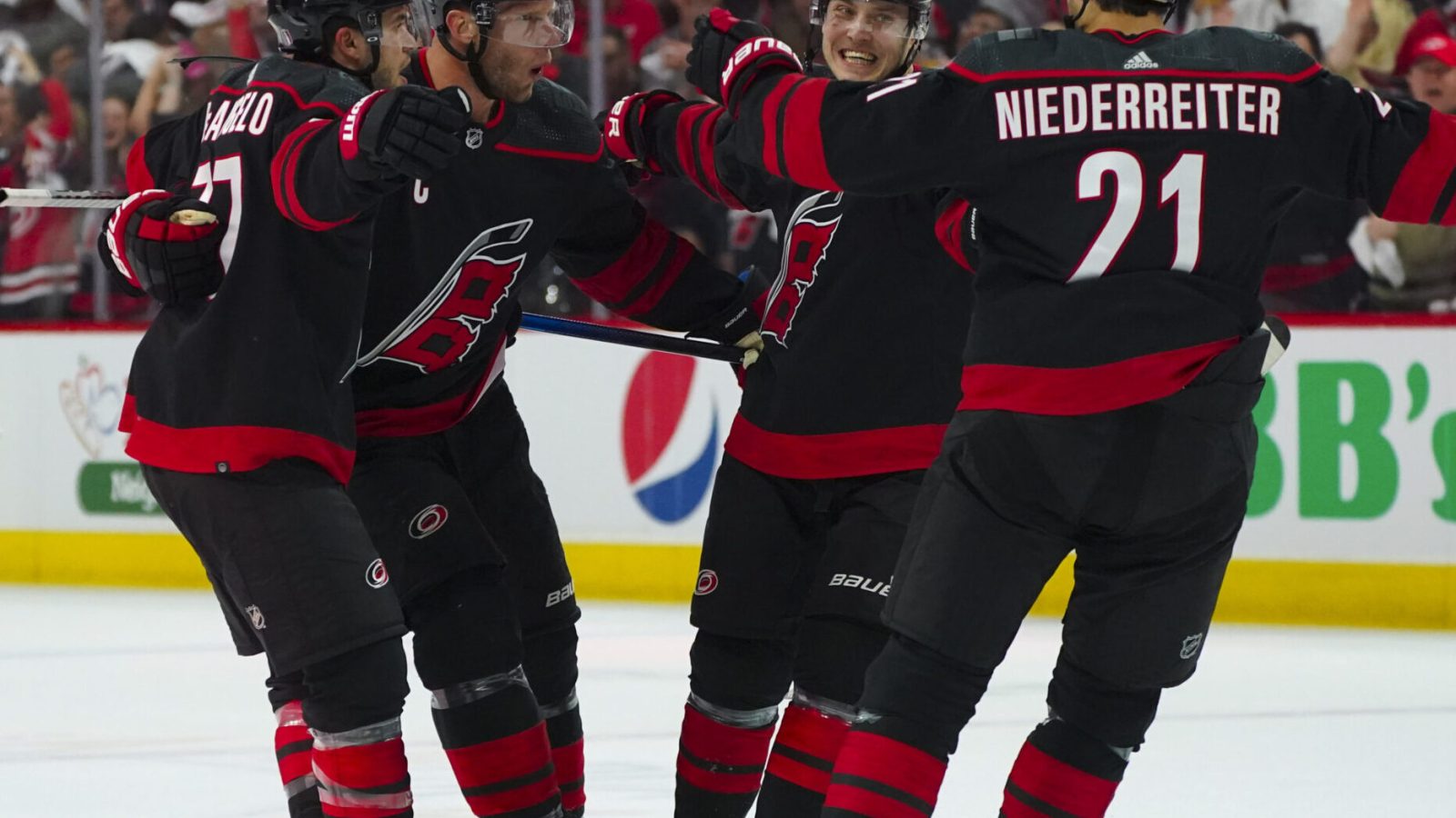 Carolina Hurricanes players Jesper Fast, Nino Niederreiter, Tony DeAngelo and center Jordan Staal after Fast's goal during Game 2 of the 2022 Stanley Cup Playoffs