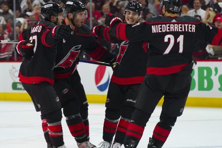 Carolina Hurricanes players Jesper Fast, Nino Niederreiter, Tony DeAngelo and center Jordan Staal after Fast's goal during Game 2 of the 2022 Stanley Cup Playoffs