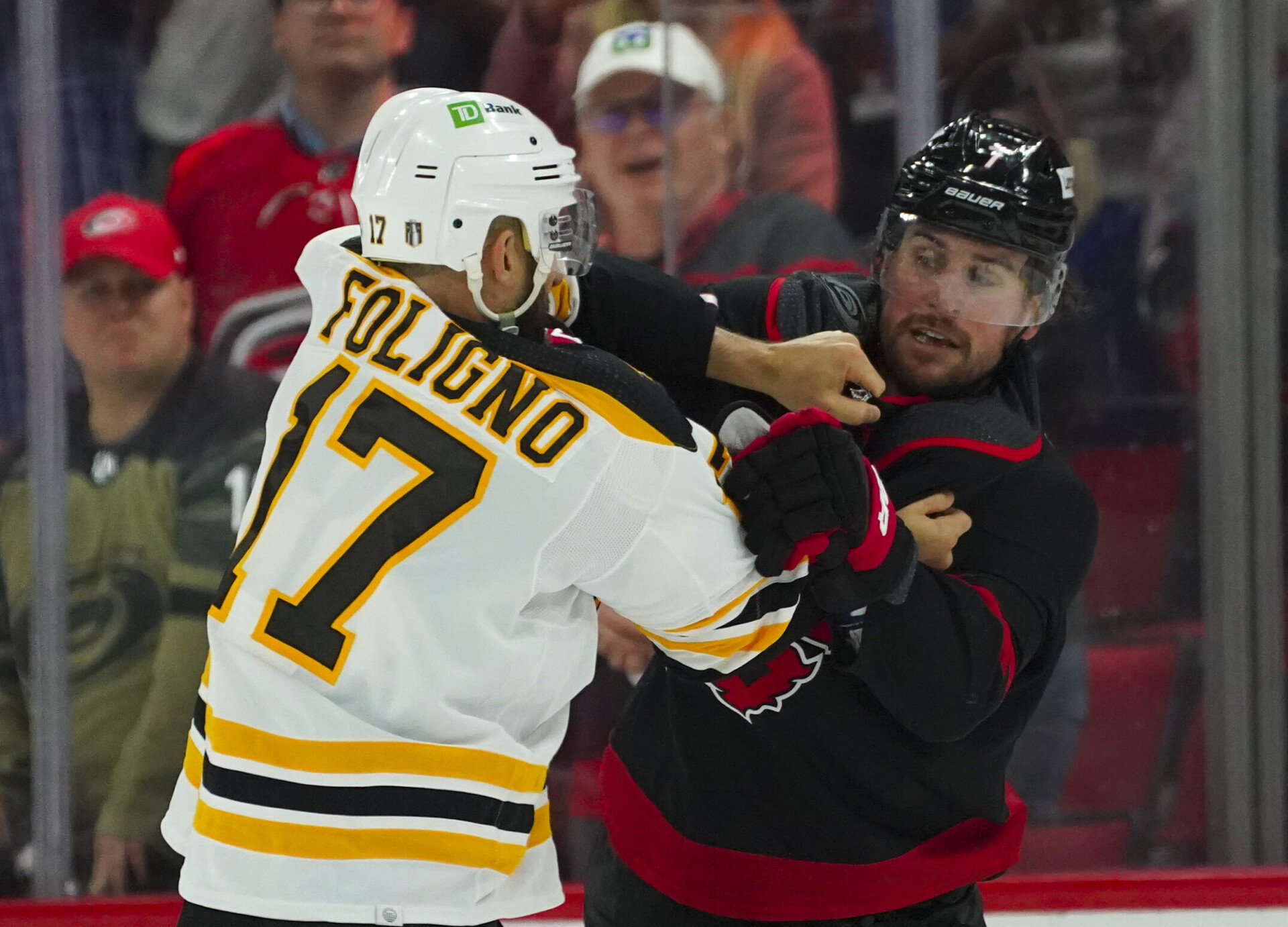 Carolina Hurricanes defenseman Brendan Smith (right) and Boston Bruins left wing Nick Foligno (left) fight during Game 2 of the 2022 Stanley Cup Playoffs