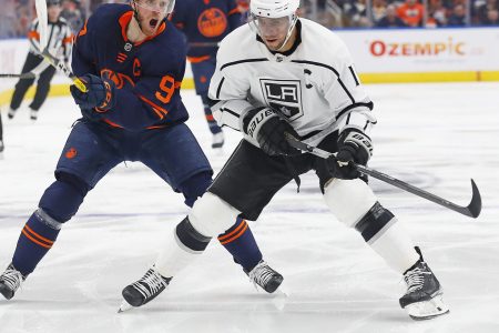 Edmonton Oilers forward Connor McDavid (left) and Los Angeles Kings forward Anze Kopitar (right) chase a loose puck during Game 2 of a Stanley Cup Playoff series