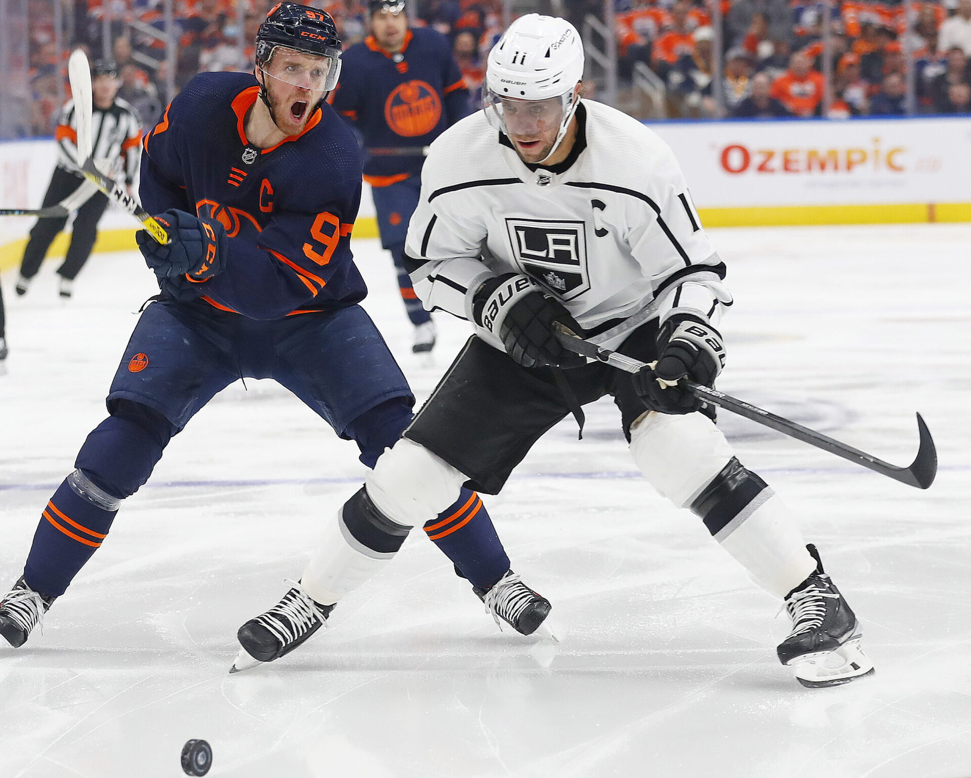 Edmonton Oilers forward Connor McDavid (left) and Los Angeles Kings forward Anze Kopitar (right) chase a loose puck during Game 2 of a Stanley Cup Playoff series