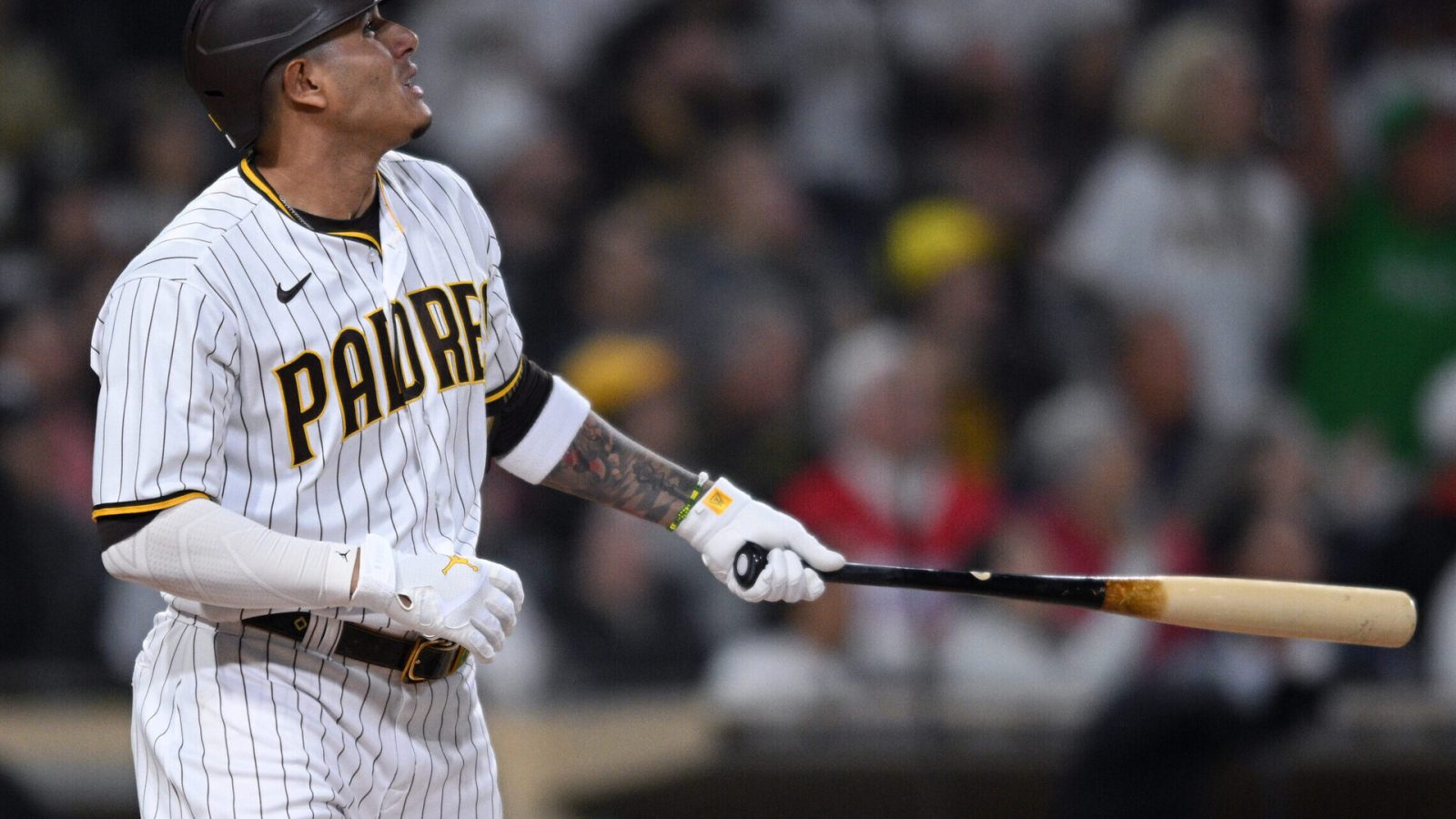San Diego Padres third baseman Manny Machado holds his bat in his left hand and admires his home run against the Miami Marlins