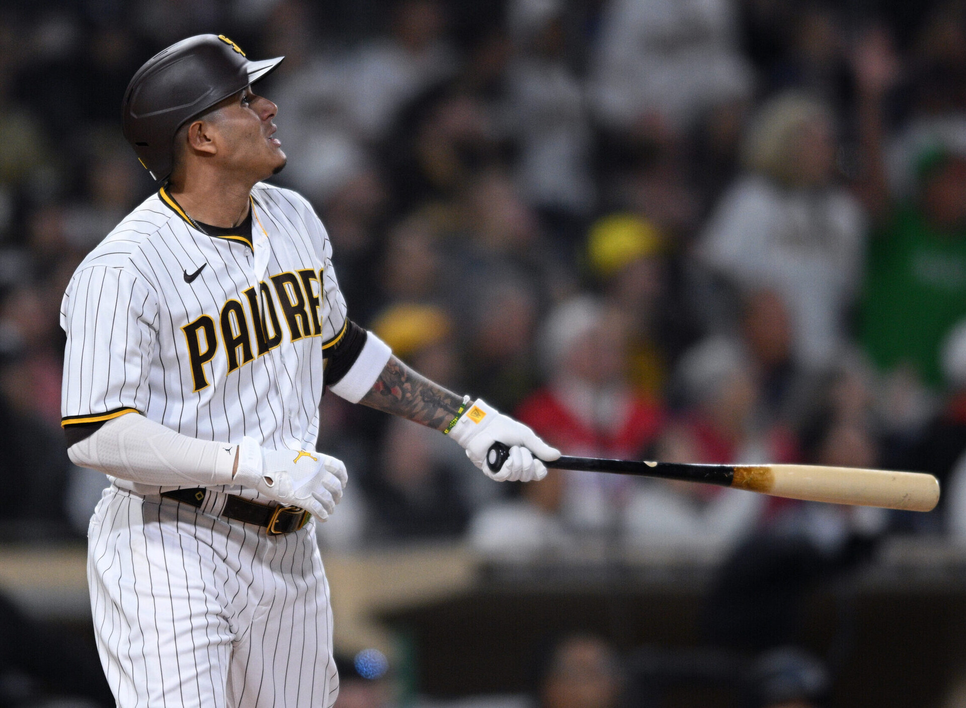 San Diego Padres third baseman Manny Machado holds his bat in his left hand and admires his home run against the Miami Marlins