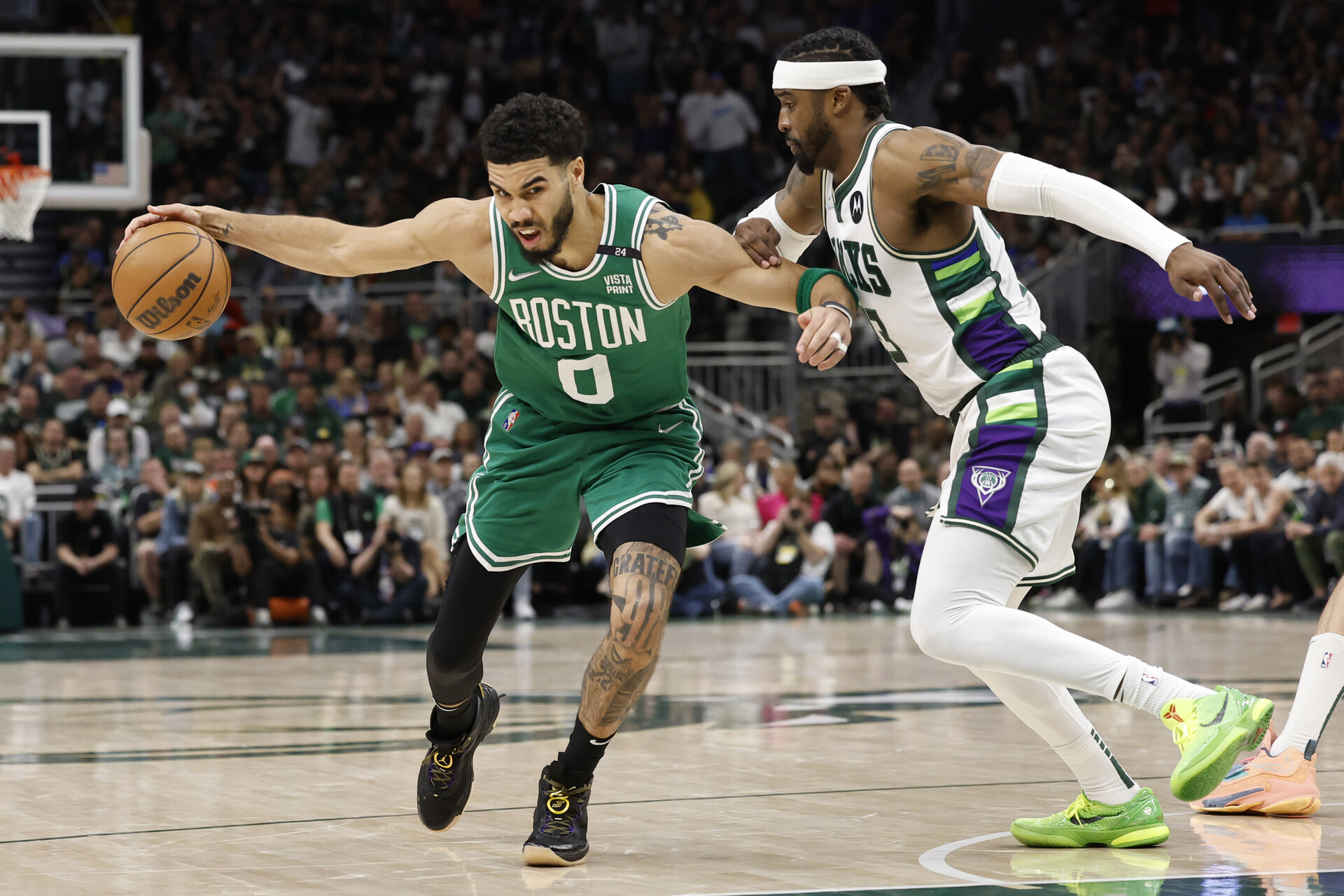 Boston Celtics forward Jayson Tatum (left) drives for the basket against Milwaukee Bucks guard Wesley Matthews (right) during the fourth quarter during game three of the second round for the 2022 NBA playoffs at Fiserv Forum.