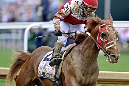 Sonny Leon aboard Rich Strike celebrates winning the 148th running of the Kentucky Derby at Churchill Downs on May 7, 2022.