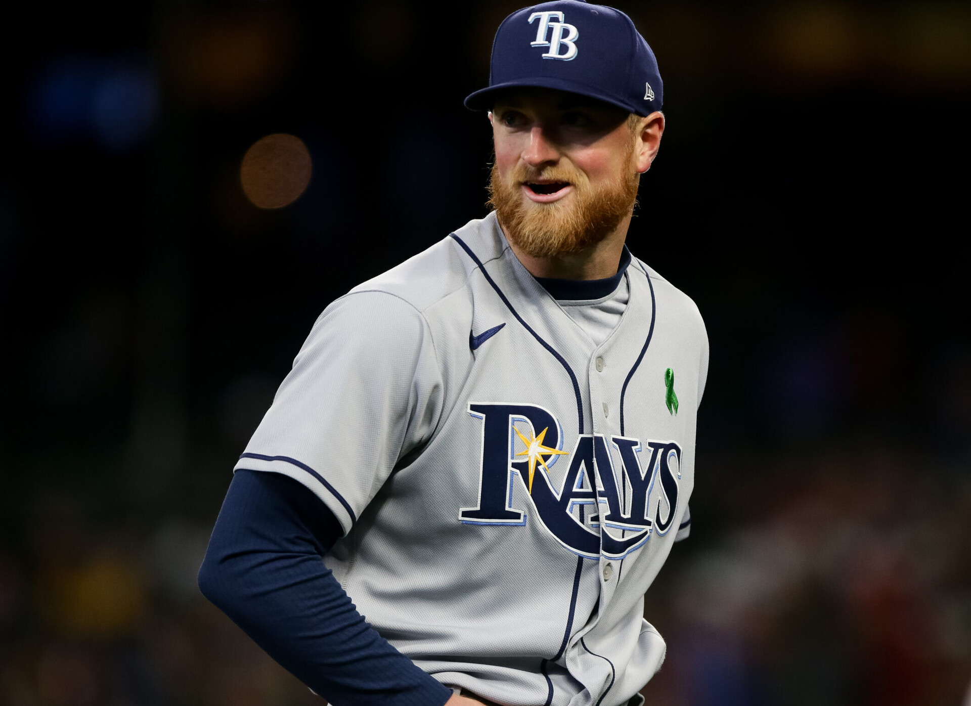 Tampa Bay Rays right-handed pitcher Drew Rasmussen smiles as he walks off the field against the Seattle Mariners on May 7, 2022, in Seattle.