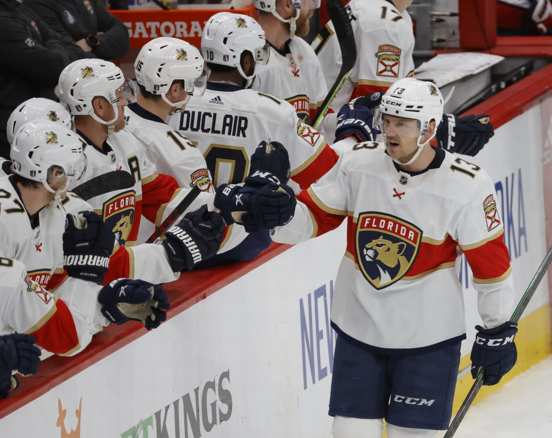 Florida Panthers center Sam Reinhart (right) celebrates with teammates on the bench after scoring the game-tying goal against the Washington Capitals during a 2022 Stanley Cup Playoffs game