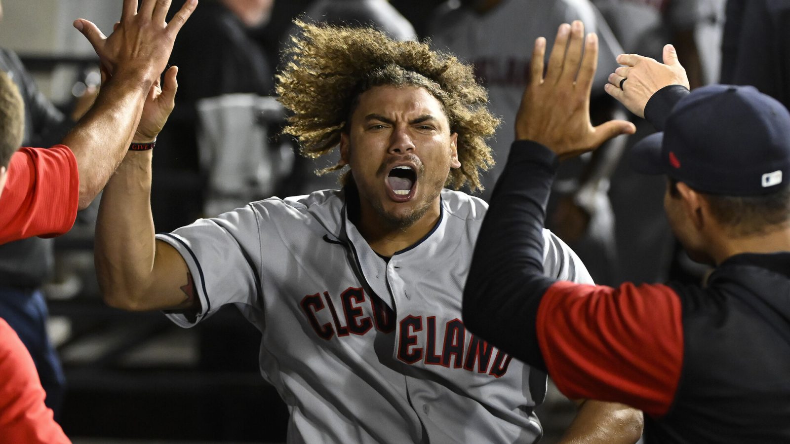Cleveland Guardians first baseman Josh Naylor celebrates in the dugout with teammates after hitting a three-run home run in the 11th inning against the Chicago White Sox