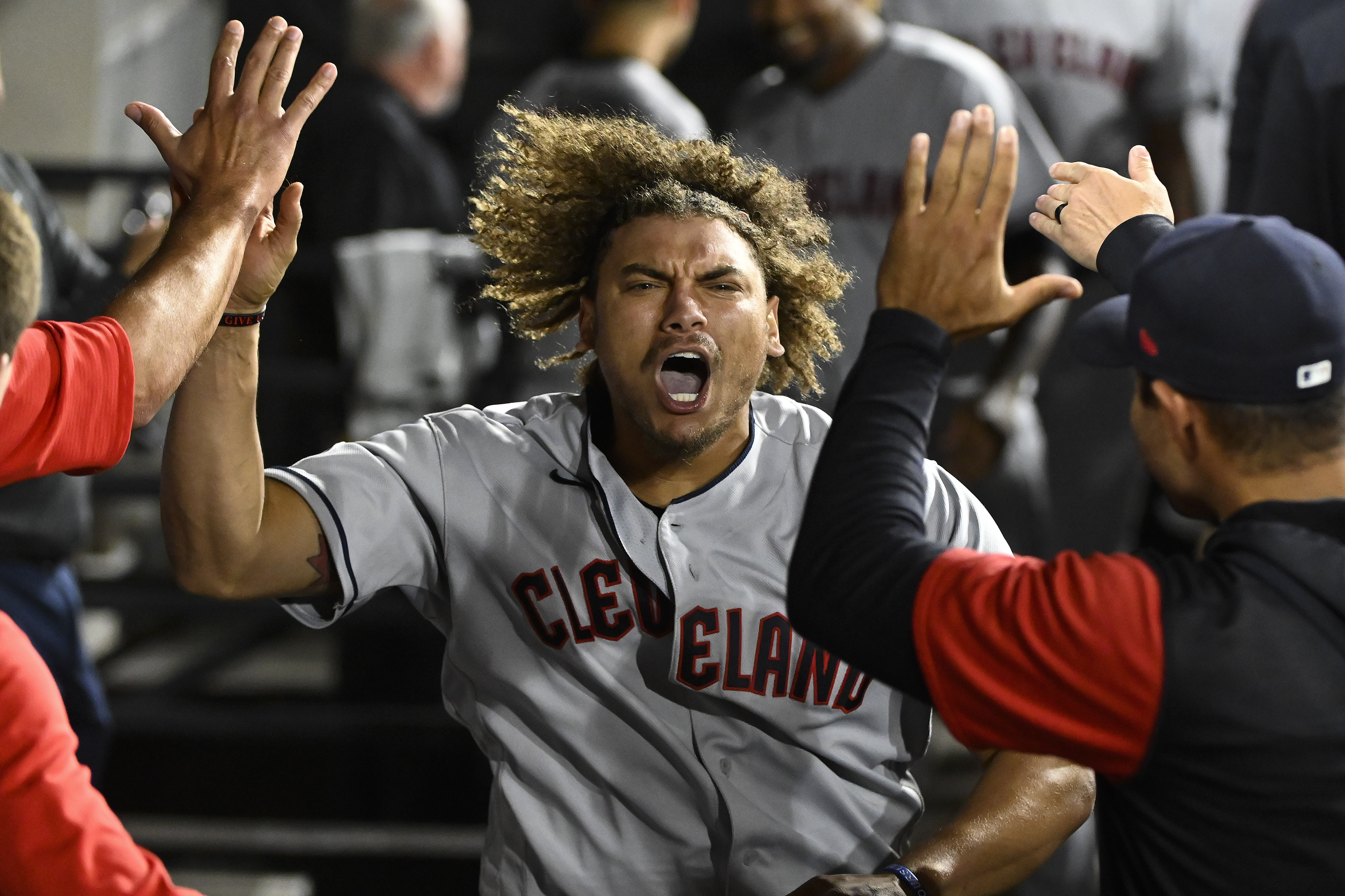 Cleveland Guardians first baseman Josh Naylor celebrates in the dugout with teammates after hitting a three-run home run in the 11th inning against the Chicago White Sox