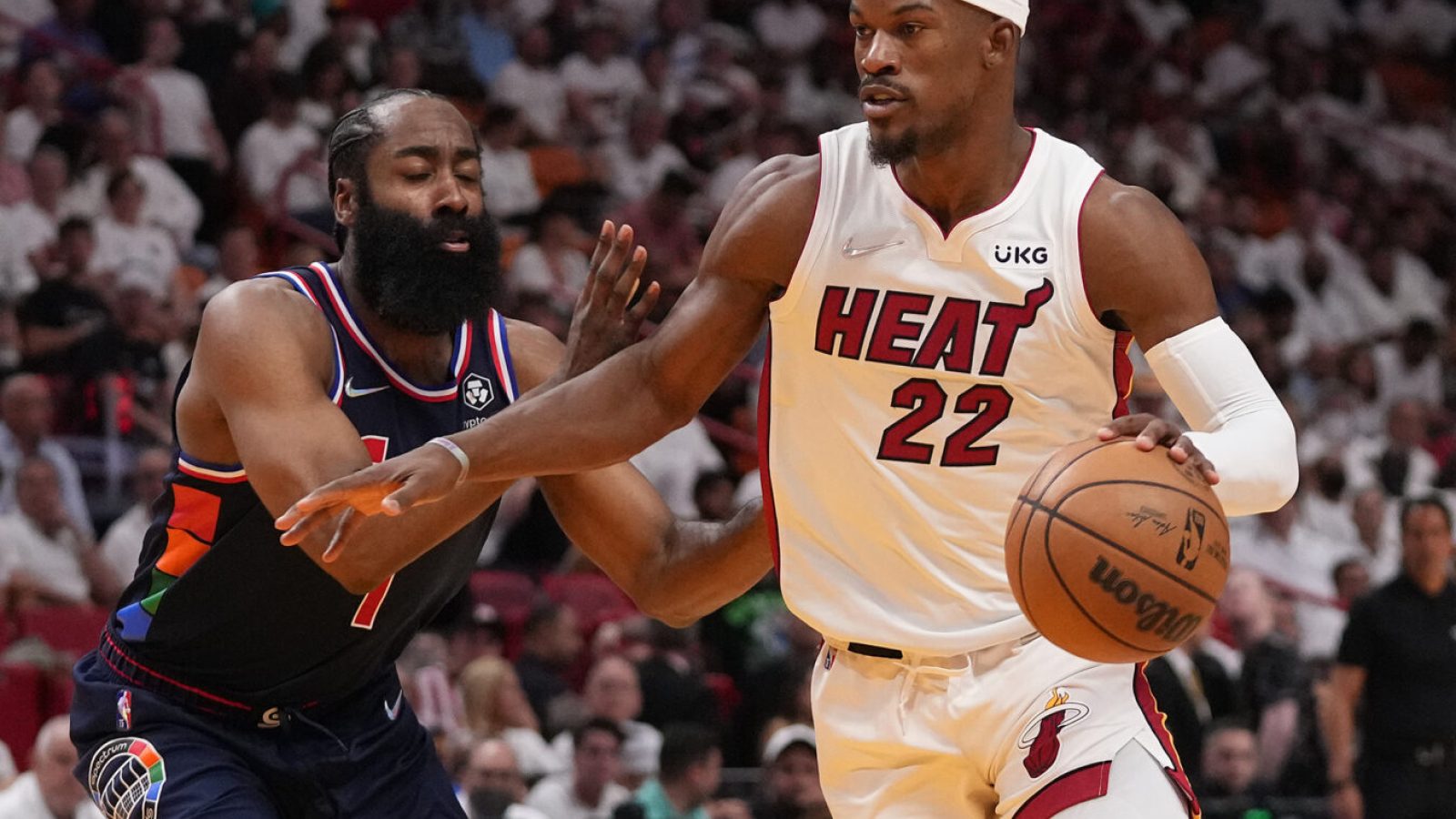 Miami Heat forward Jimmy Butler, right, drives the ball around Philadelphia 76ers guard James Harden, left, during the second half in game five of the second round for the 2022 NBA playoffs at FTX Arena on May 10, 2022.