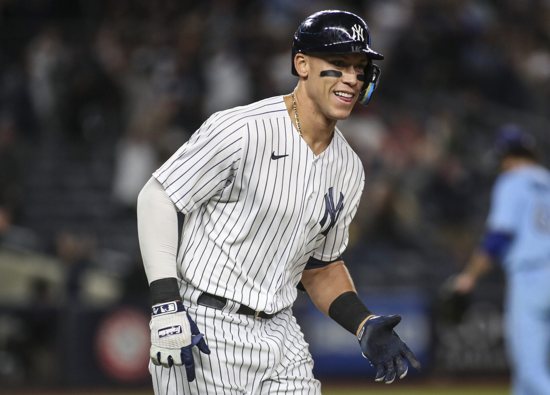 New York Yankees outfielder Aaron Judge smiles as he rounds the bases after hitting the game-winning home run against the Toronto Blue Jays on Tuesday, May 10, 2022, in New York.