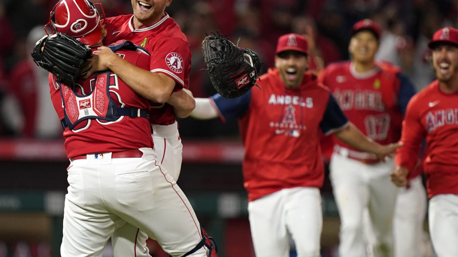 Los Angeles Angels starting pitcher Reid Detmers is lifted in the air by catcher Chad Wallach after throwing a no hitter against the Tampa Bay Rays