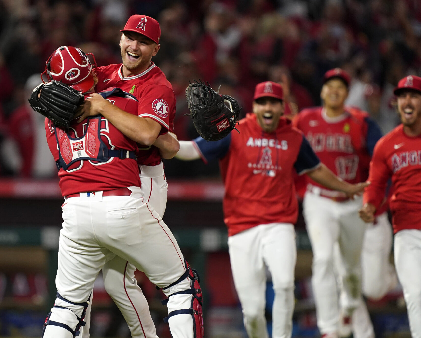 Los Angeles Angels starting pitcher Reid Detmers is lifted in the air by catcher Chad Wallach after throwing a no hitter against the Tampa Bay Rays