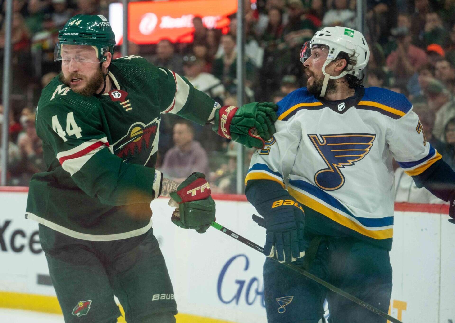 Minnesota Wild left wing Nicolas Deslauriers (left) and St. Louis Blues defenseman Justin Faulk (right) collide in the second period during a 2022 Stanley Cup Playoffs game