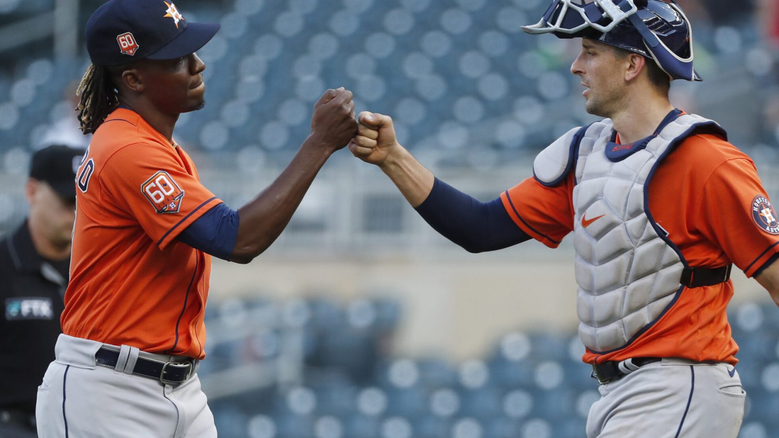 Houston Astros pitcher Rafael Montero, left, and catcher Jason Castro, right, bump fists after Houston's victory over the Twins on May 12, 2022, in Minneapolis.