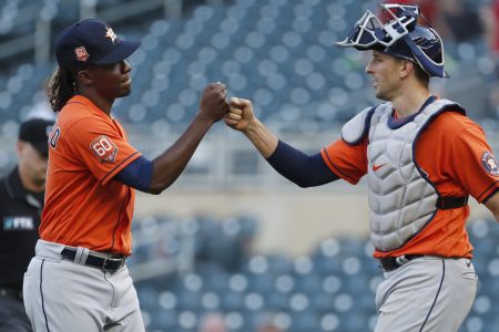 Houston Astros pitcher Rafael Montero, left, and catcher Jason Castro, right, bump fists after Houston's victory over the Twins on May 12, 2022, in Minneapolis.