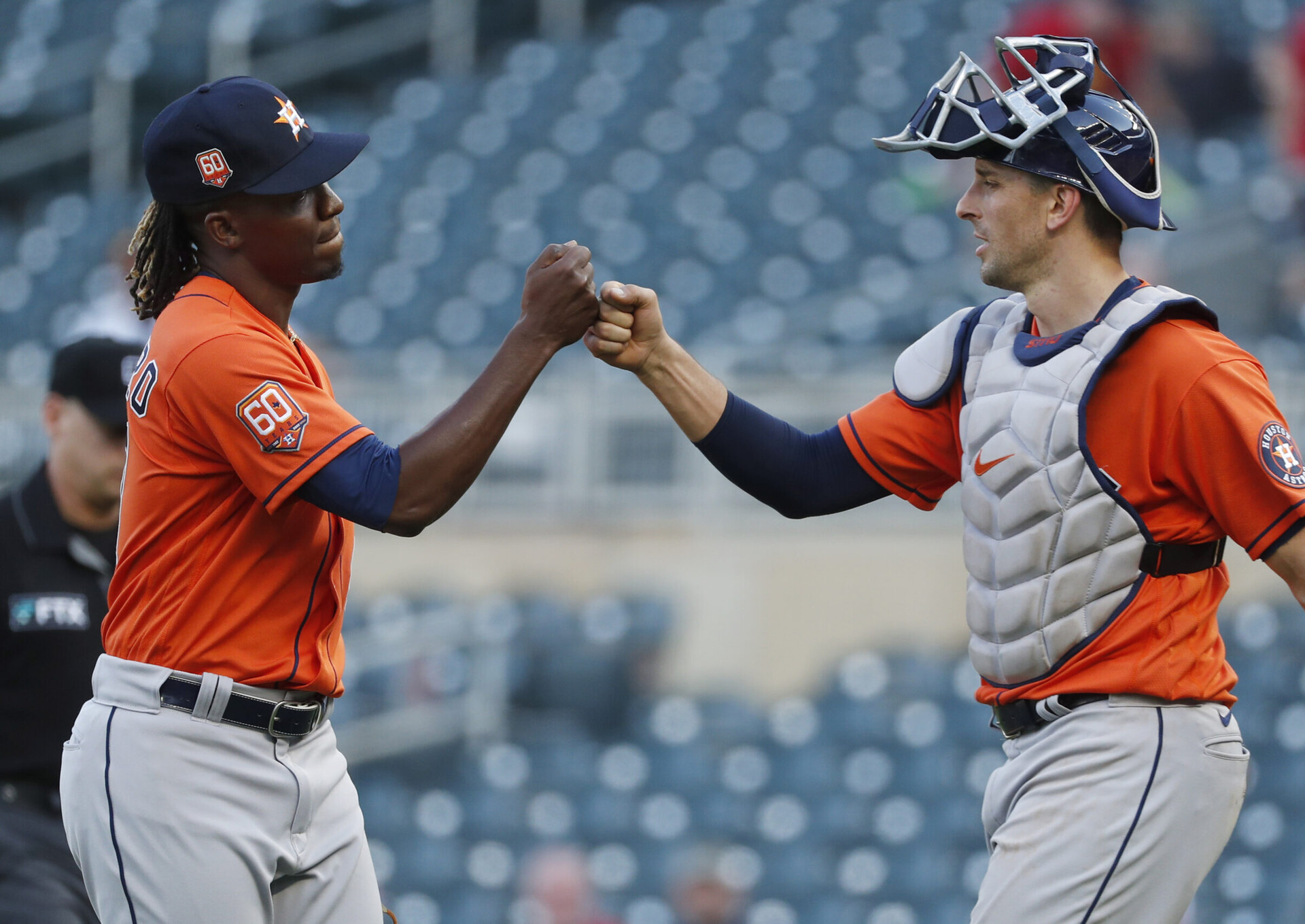 Houston Astros pitcher Rafael Montero, left, and catcher Jason Castro, right, bump fists after Houston's victory over the Twins on May 12, 2022, in Minneapolis.