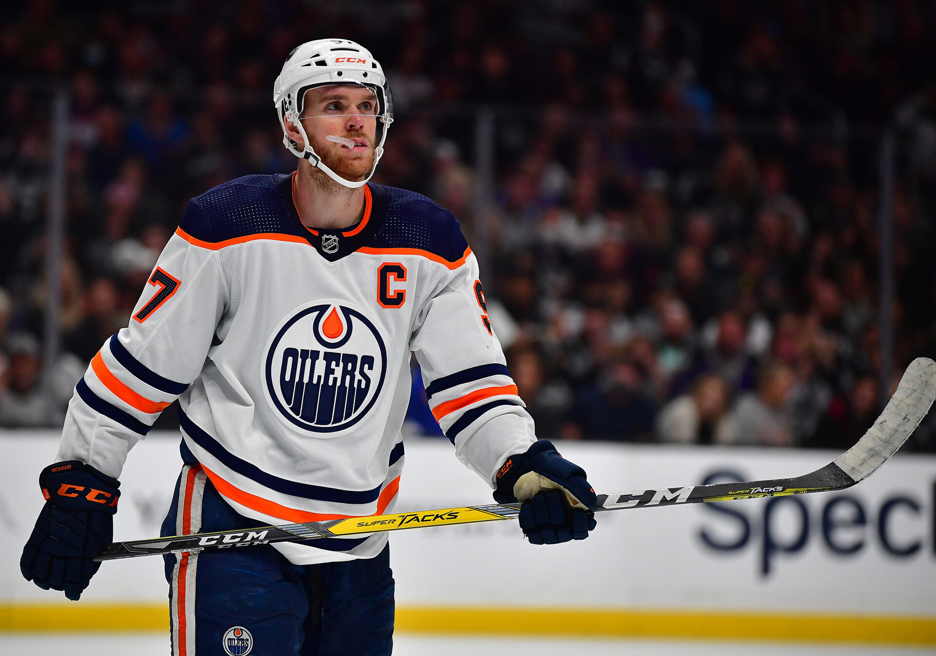 Edmonton Oilers center Connor McDavid chews on his mouthpiece and looks toward the crowd during a break in the action in a 2022 Stanley Cup Playoff game against the Los Angeles Kings during the third period in game