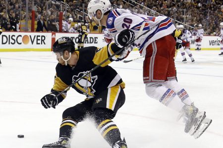 New York Rangers left wing Chris Kreider, right, leaps into the air as he tries to get by Pittsburgh Penguins defenseman Mike Matheson, left, on Friday, May 13, 2022, in Pittsburgh.