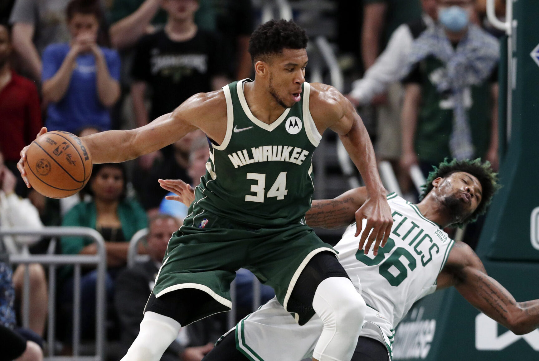 Milwaukee Bucks forward Giannis Antetokounmpo, left, drives into Boston Celtics guard Marcus Smart, right, during the fourth quarter during game six of the second round for the 2022 NBA playoffs at Fiserv Forum on May 13, 2022.
