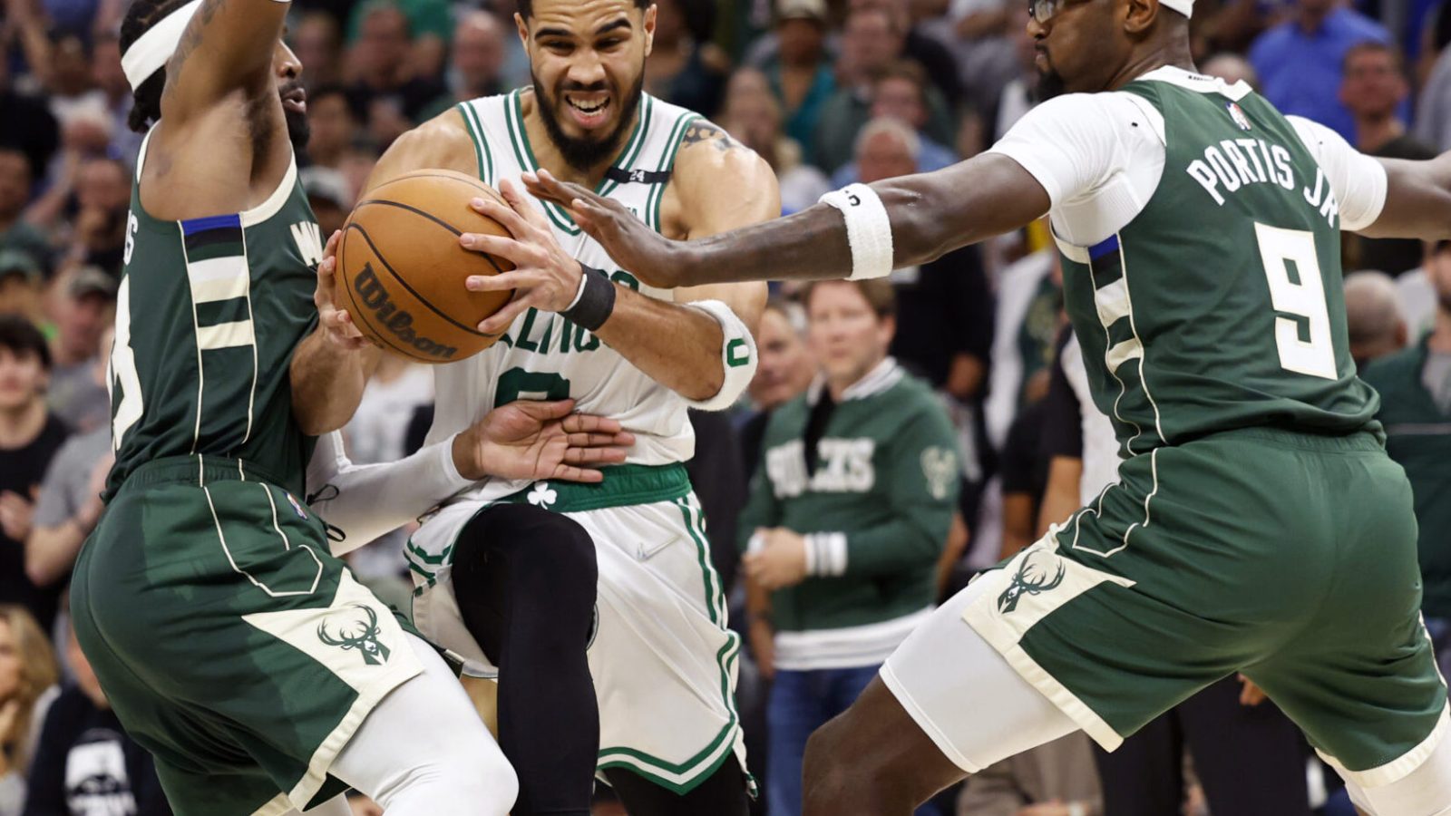 Boston Celtics forward Jayson Tatum, middle, drives for the basket between Milwaukee Bucks guard Wesley Matthews, left, and forward Bobby Portis, right, during the fourth quarter during game six of the second round for the 2022 NBA playoffs at Fiserv Forum on May 13, 2022.