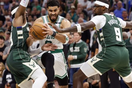 Boston Celtics forward Jayson Tatum, middle, drives for the basket between Milwaukee Bucks guard Wesley Matthews, left, and forward Bobby Portis, right, during the fourth quarter during game six of the second round for the 2022 NBA playoffs at Fiserv Forum on May 13, 2022.