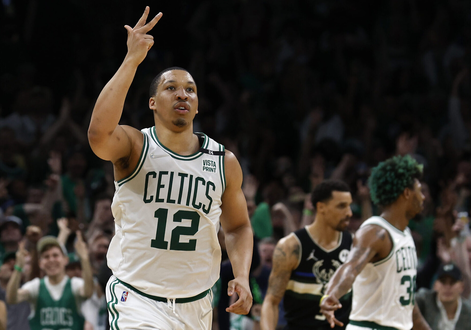 Boston Celtics forward Grant Williams (12) celebrates after making a three point basket against the Milwaukee Bucks during the second half of game seven of the second round of the 2022 NBA playoffs at TD Garden.