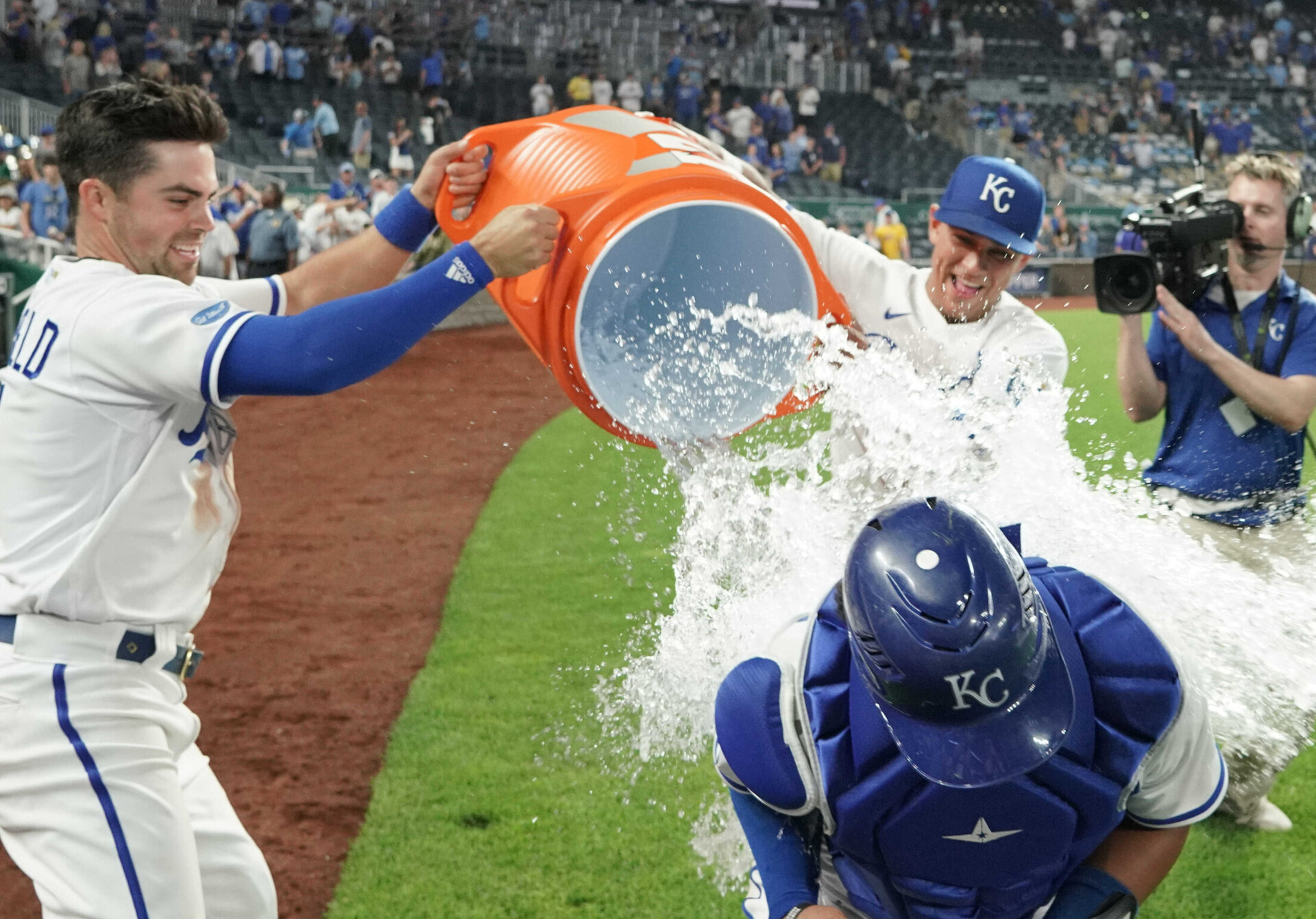 Kansas City Royals catcher MJ Melendez, middle, is doused by designated hitter Whit Merrifield, left, and second baseman Nicky Lopez, rear, after the win over the Chicago White Sox at Kauffman Stadium on May 17, 2022.