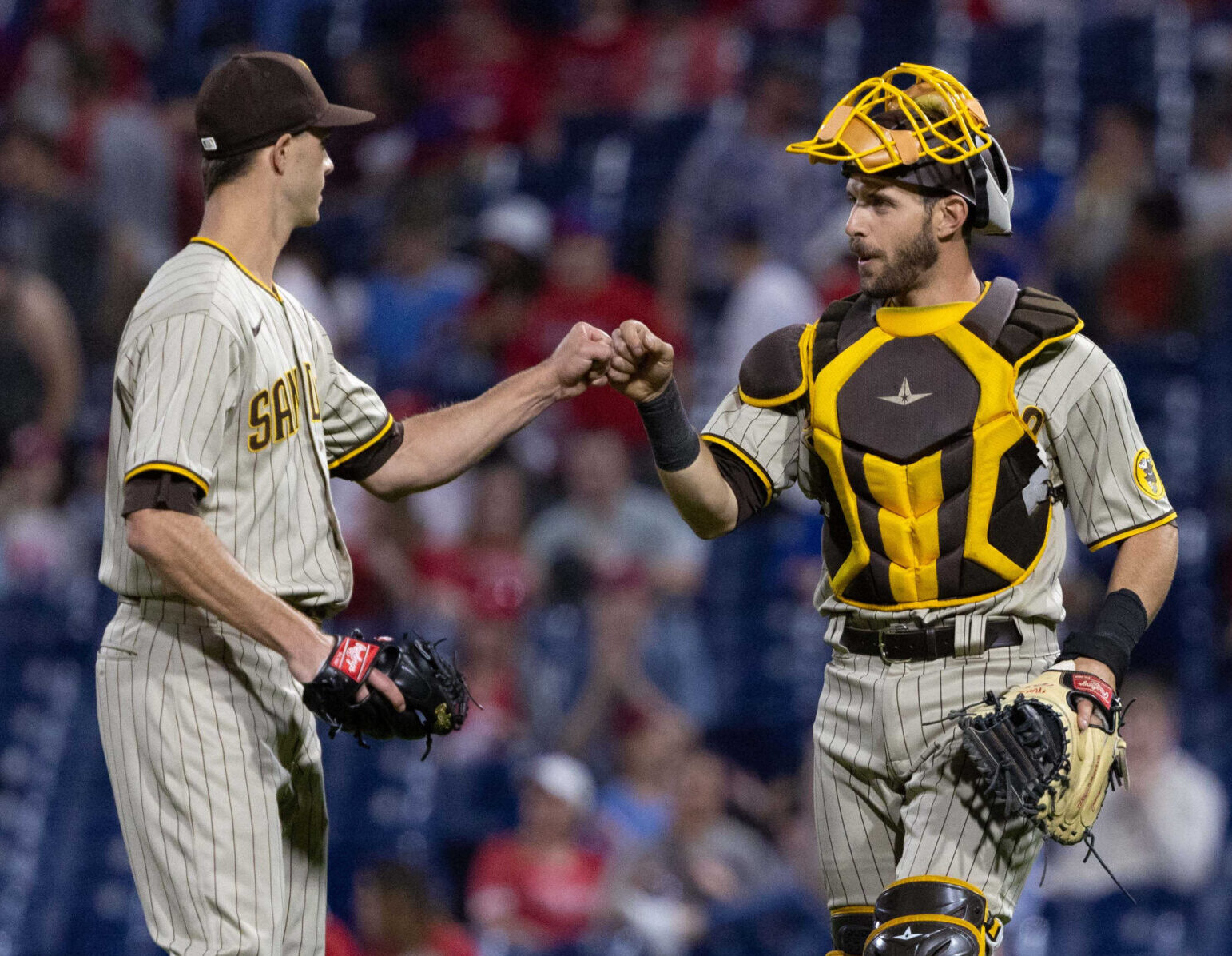 San Diego Padres catcher Austin Nola, right, and relief pitcher Taylor Rogers, left, celebrate a victory against the Philadelphia Phillies at Citizens Bank Park on May 17, 2022.