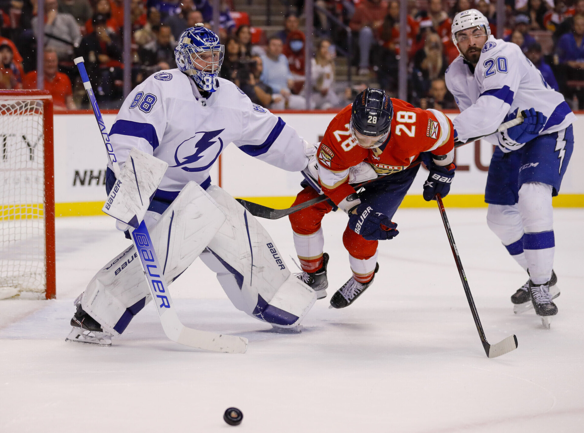 Tampa Bay Lightning goaltender Andrei Vasilevskiy (left) and left wing Nicholas Paul (right) try to prevent Florida Panthers right wing Claude Giroux (center) from getting to a loose puck during the second period in game one of the second round of the 2022 Stanley Cup Playoffs