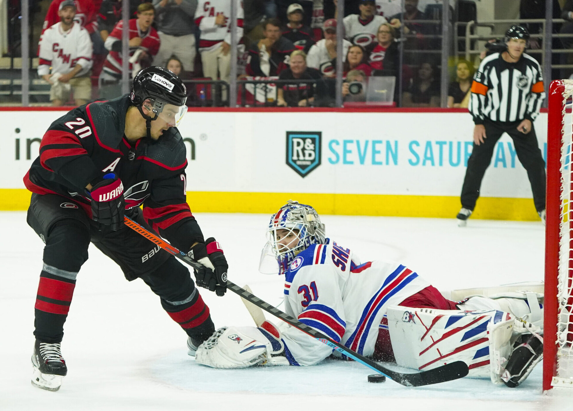 Carolina Hurricanes center Sebastian Aho (left) scores a goal past New York Rangers goaltender Igor Shesterkin (right) during the third period in game one of the second round of the 2022 Stanley Cup Playoffs