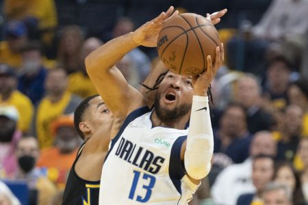 Dallas Mavericks guard Jalen Brunson, right, goes up for a shot with both hands as he moves past Golden State Warriors guard Jordan Poole, left, on Wednesday, May 18, 2022, in San Francisco.