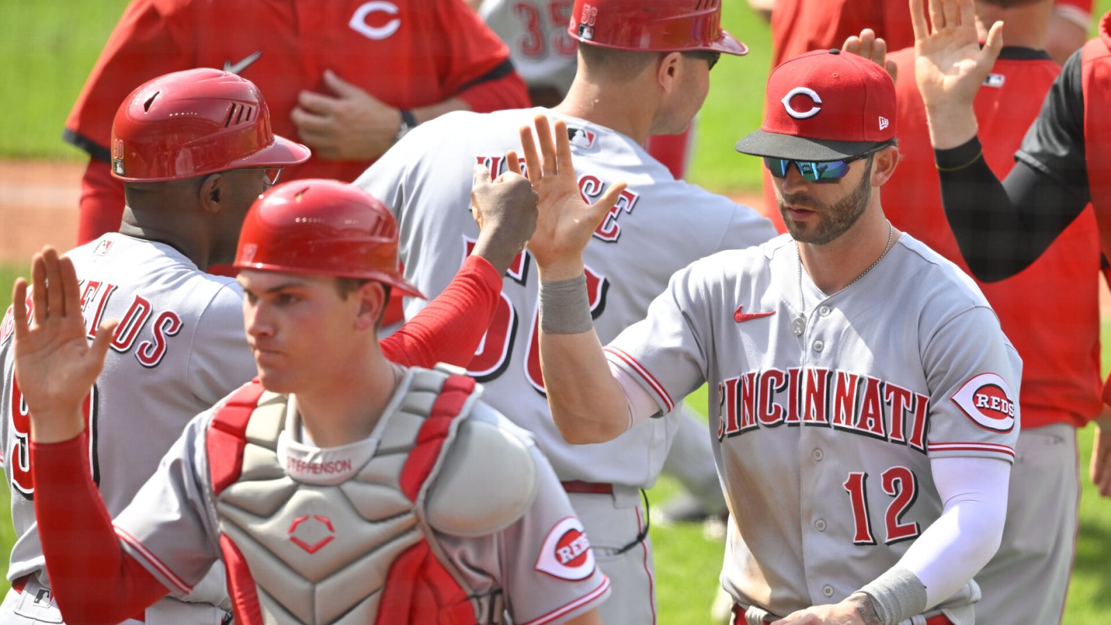 Cincinnati Reds designated hitter Tyler Naquin (12) celebrates a win over the Cleveland Guardians