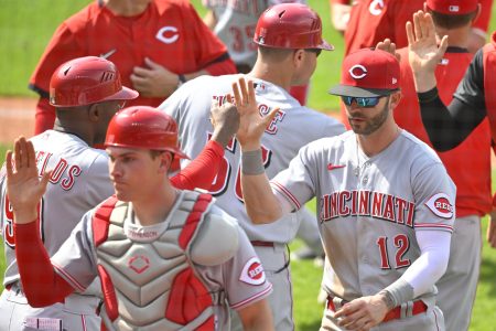 Cincinnati Reds designated hitter Tyler Naquin (12) celebrates a win over the Cleveland Guardians