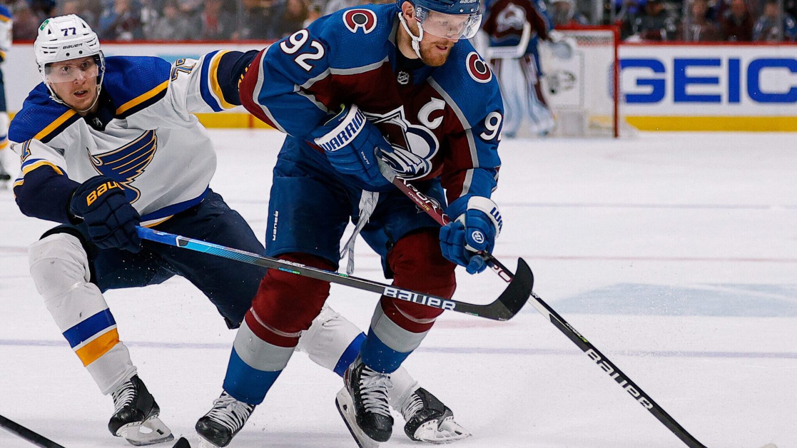 Colorado Avalanche left wing Gabriel Landeskog (right) controls the puck under pressure from St. Louis Blues defenseman Niko Mikkola (left) in the second period in game two of the second round of the 2022 Stanley Cup Playoffs