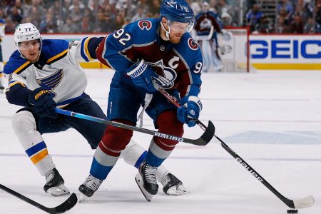 Colorado Avalanche left wing Gabriel Landeskog (right) controls the puck under pressure from St. Louis Blues defenseman Niko Mikkola (left) in the second period in game two of the second round of the 2022 Stanley Cup Playoffs
