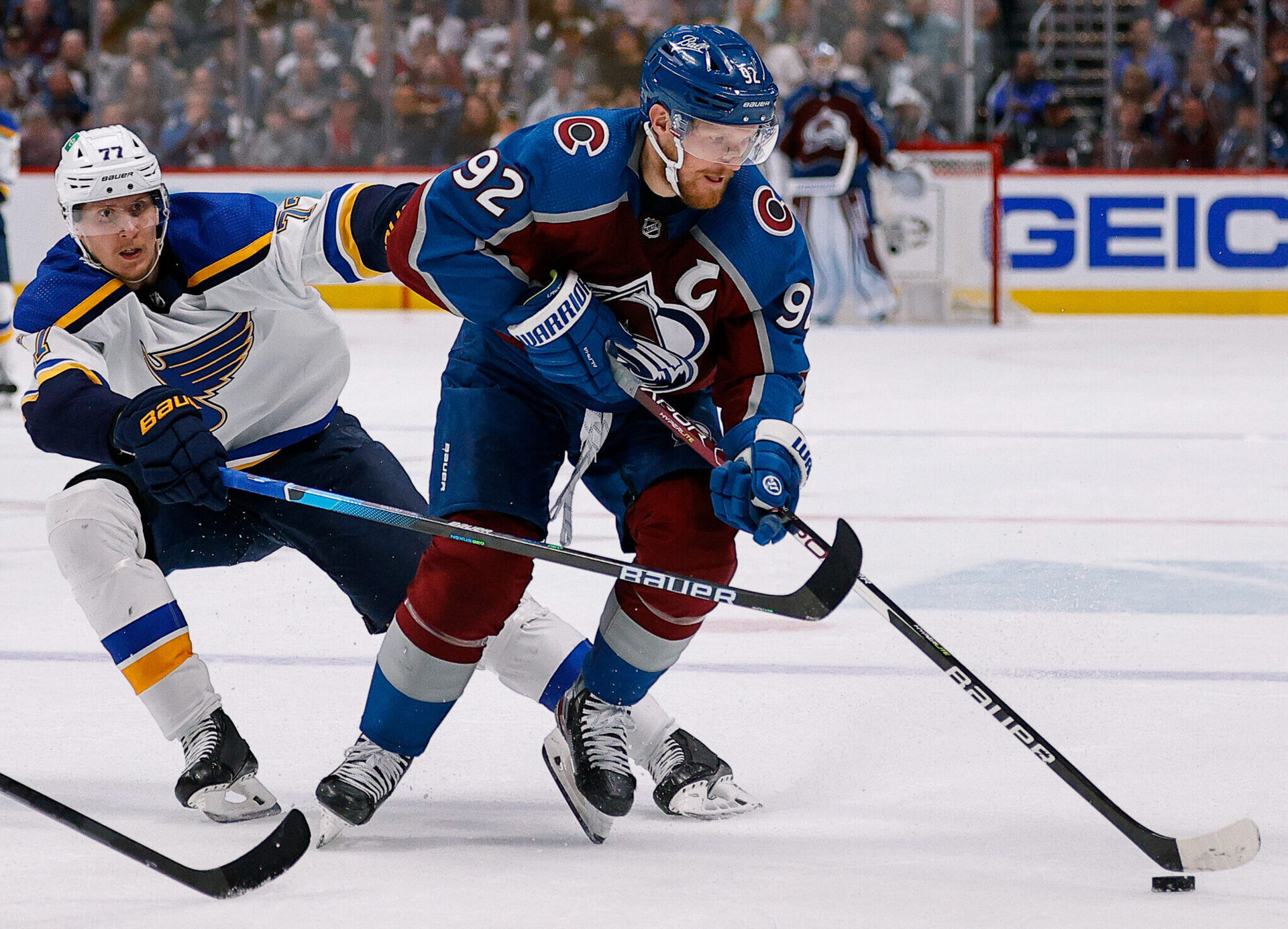 Colorado Avalanche left wing Gabriel Landeskog (right) controls the puck under pressure from St. Louis Blues defenseman Niko Mikkola (left) in the second period in game two of the second round of the 2022 Stanley Cup Playoffs
