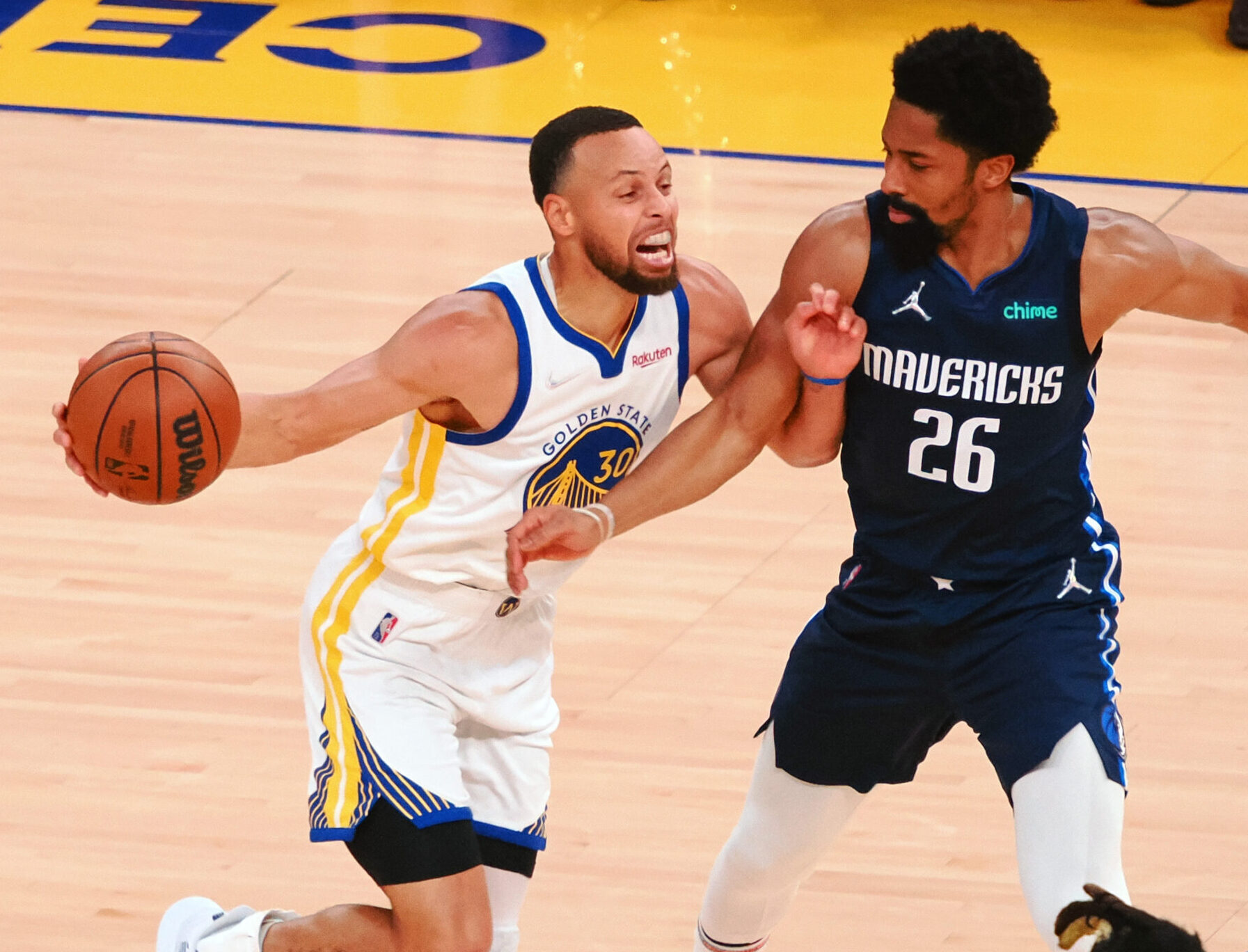 Golden State Warriors guard Stephen Curry, left, grimaces as he draws a foul from Dallas Mavericks guard Spencer Dinwiddie, right, on Friday, May 20, 2022, in San Francisco.