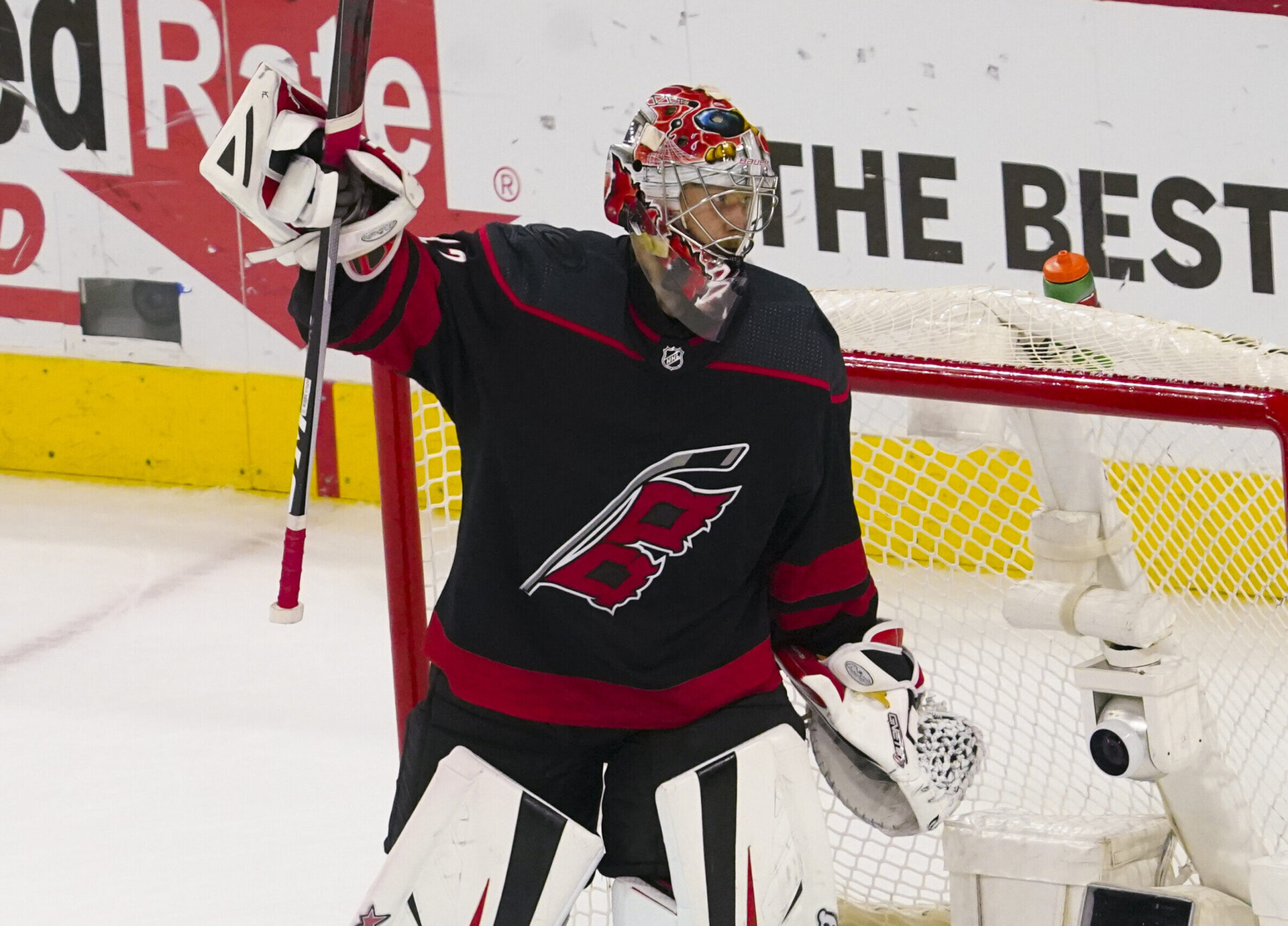 Carolina Hurricanes goaltender Antti Raanta raises his stick with his right hand as he celebrates his team's Game 2 victory over the New York Rangers in the second round of the 2022 Stanley Cup Playoffs