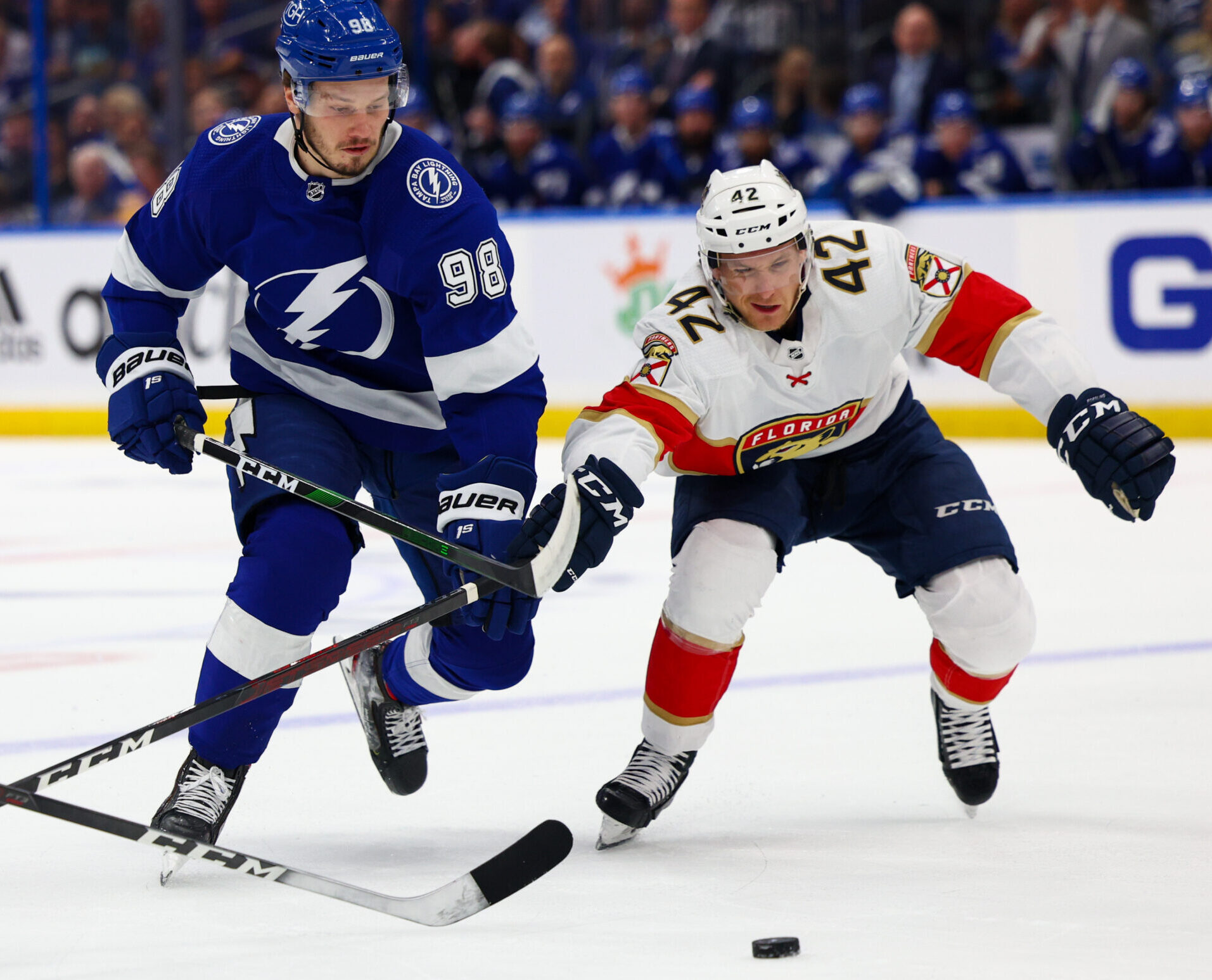Tampa Bay Lightning defenseman Mikhail Sergachev (left) and Florida Panthers defenseman Gustav Forsling (right) fight for the puck in Game 3 of the second round of the 2022 Stanley Cup Playoffs