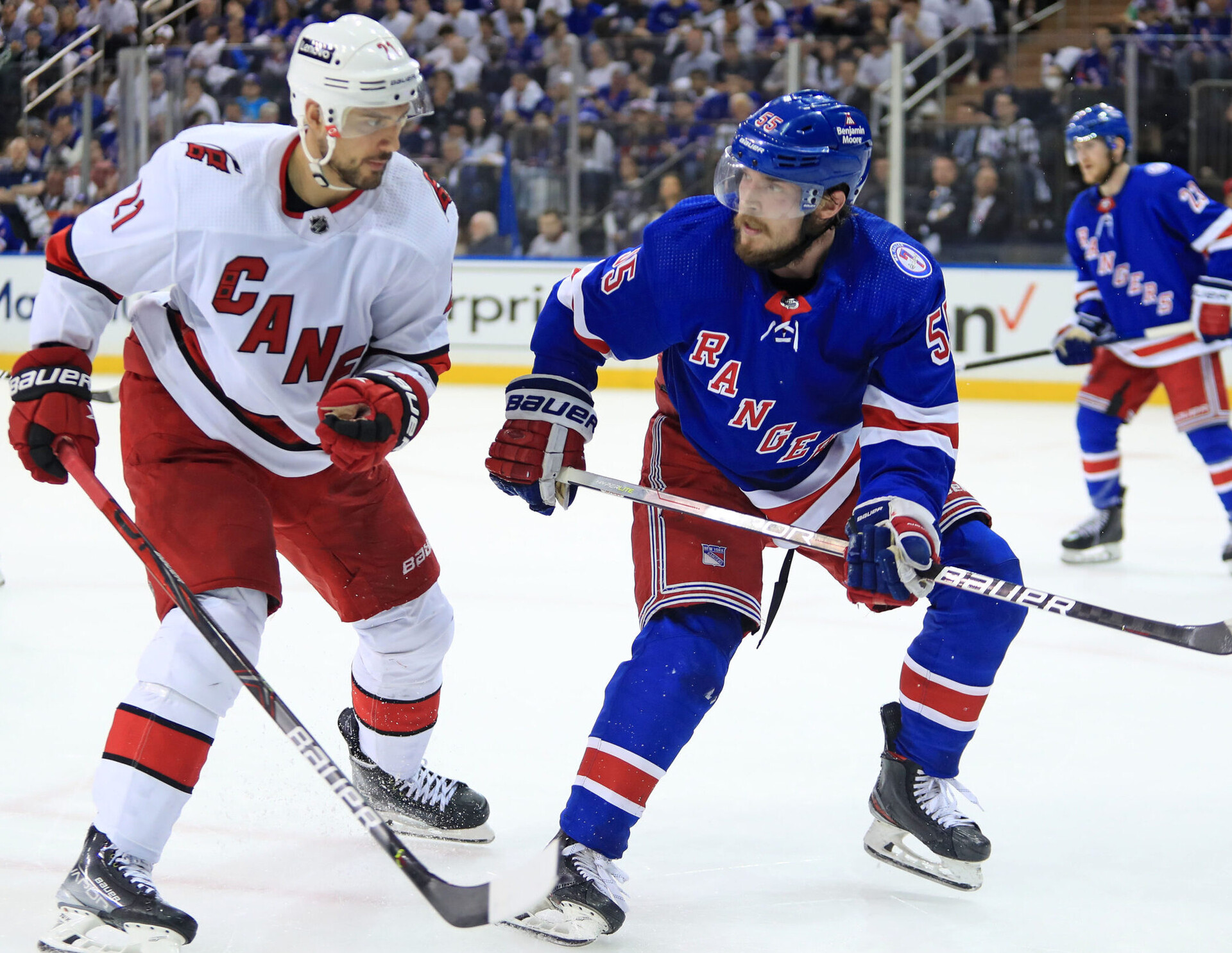 Carolina Hurricanes right wing Nino Niederreiter (left) and New York Rangers defenseman Ryan Lindgren (right) prepare to collide with each other during Game 3 of the second round of the 2022 Stanley Cup Playoffs